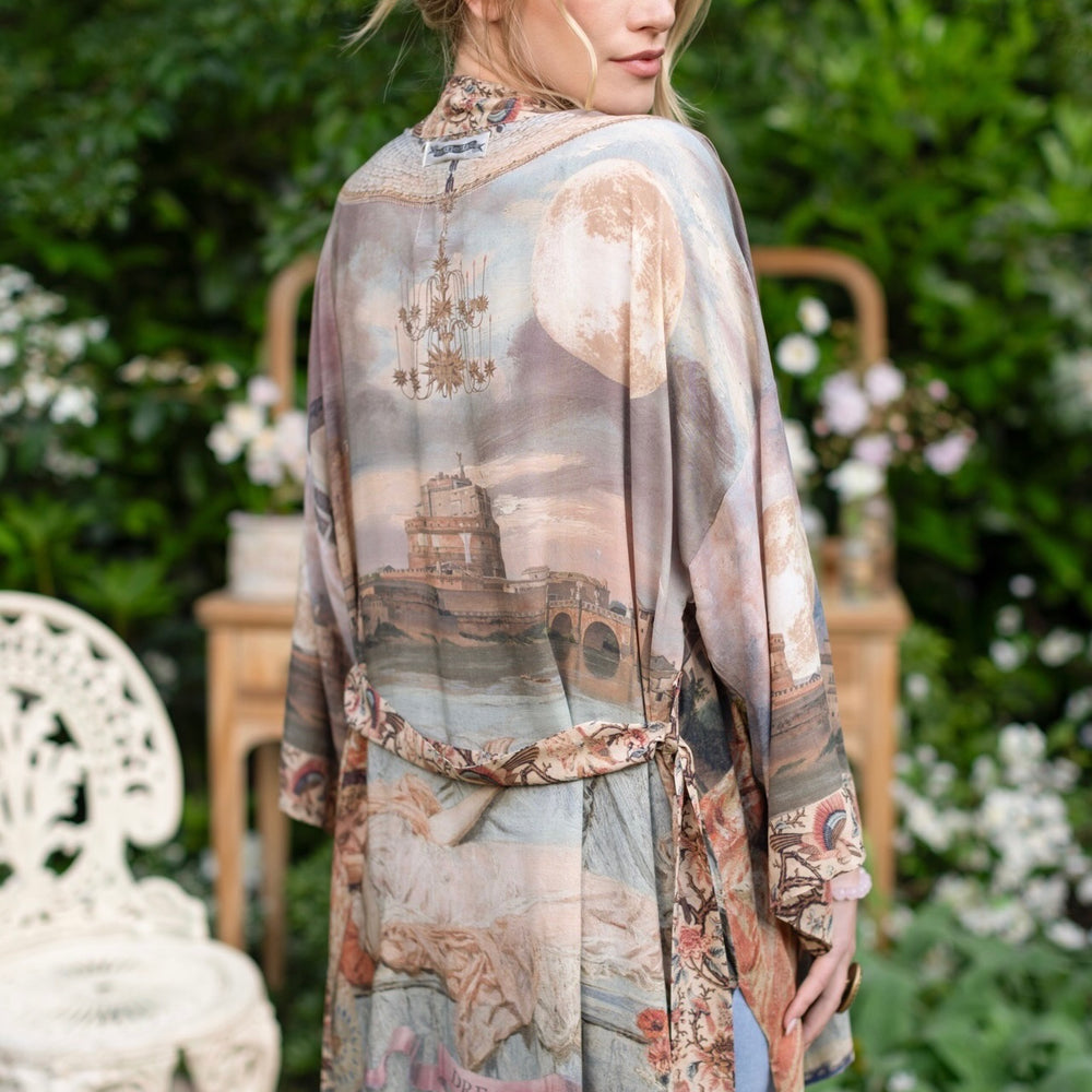 
                  
                    Model wearing the Imaginarium matinee duster featuring a dreamy collage of historic art, candle chandelier, and sleeping muse inspired by Victorian paintings – Market of Stars
                  
                