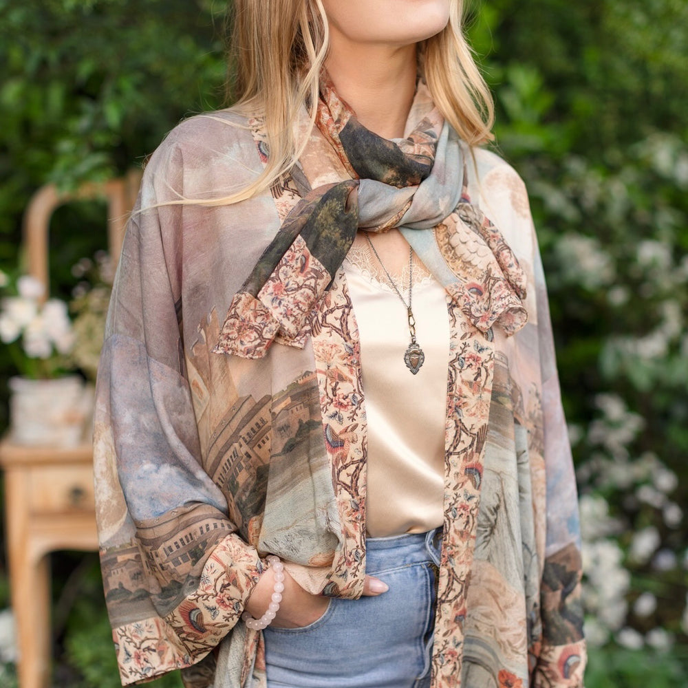 
                  
                    Model wearing the Imaginarium matinee duster featuring a dreamy collage of historic art, candle chandelier, and sleeping muse inspired by Victorian paintings – Market of Stars
                  
                