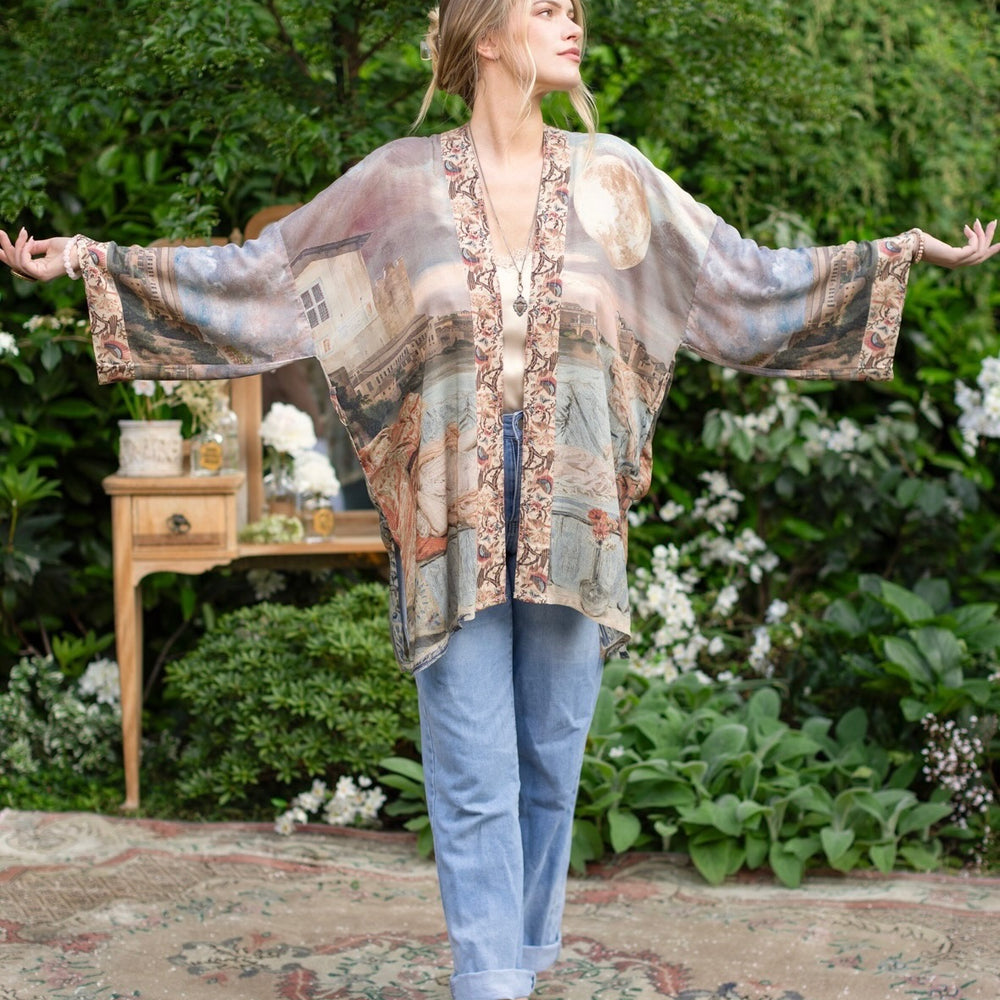 
                  
                    Model wearing the Imaginarium matinee duster featuring a dreamy collage of historic art, candle chandelier, and sleeping muse inspired by Victorian paintings – Market of Stars
                  
                
