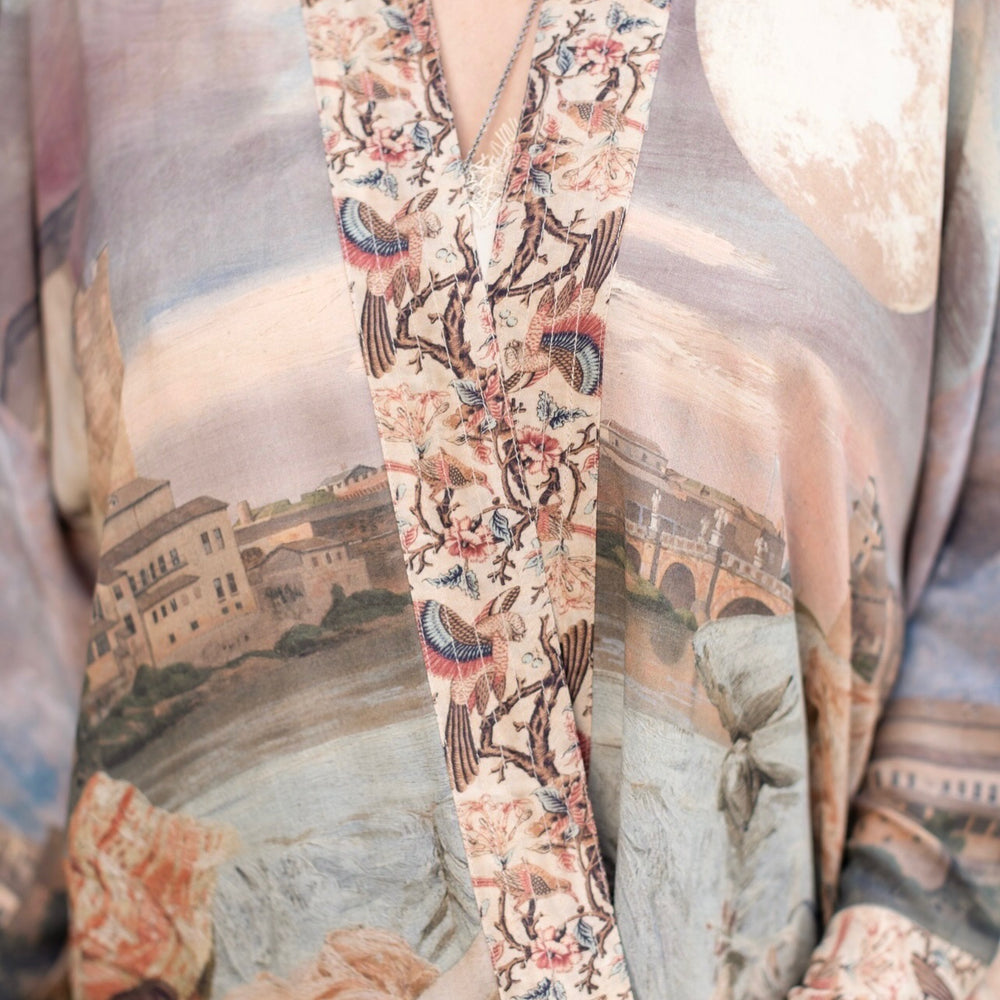 
                  
                    Model wearing the Imaginarium matinee duster featuring a dreamy collage of historic art, candle chandelier, and sleeping muse inspired by Victorian paintings – Market of Stars
                  
                