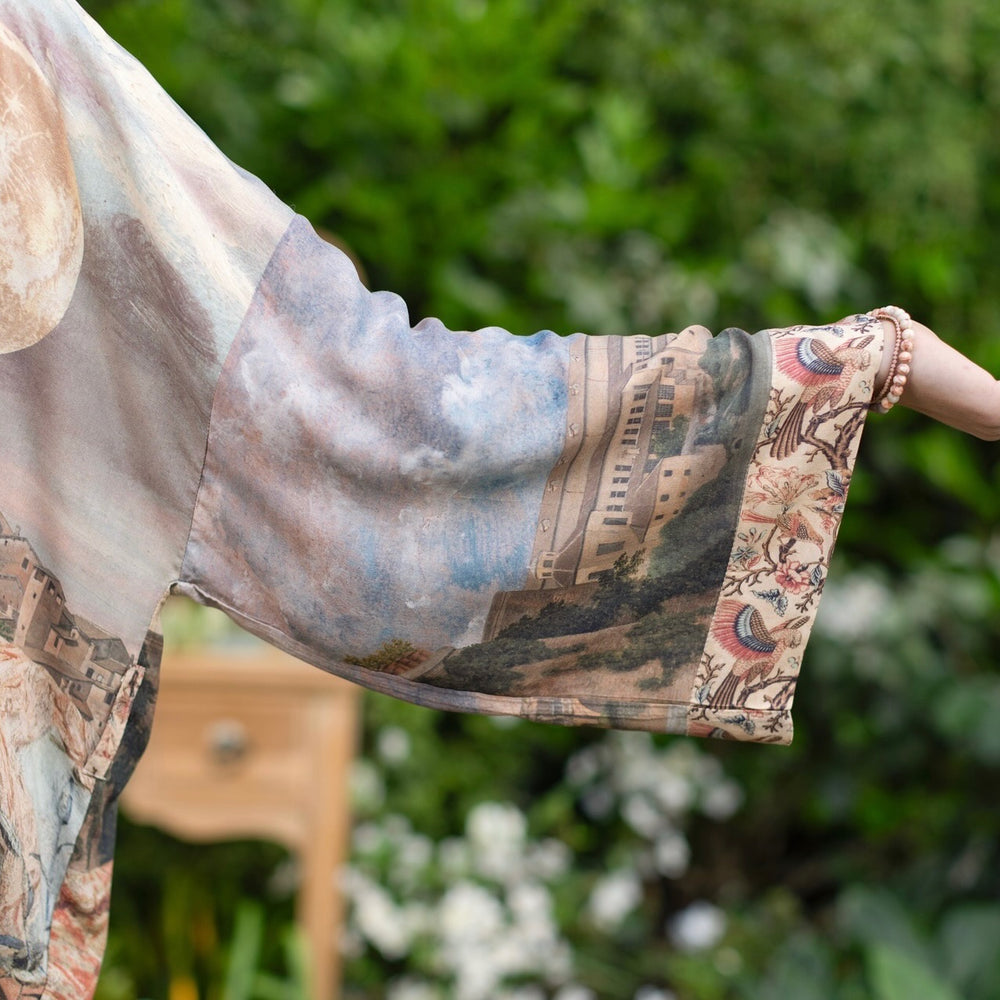 
                  
                    Model wearing the Imaginarium matinee duster featuring a dreamy collage of historic art, candle chandelier, and sleeping muse inspired by Victorian paintings – Market of Stars
                  
                