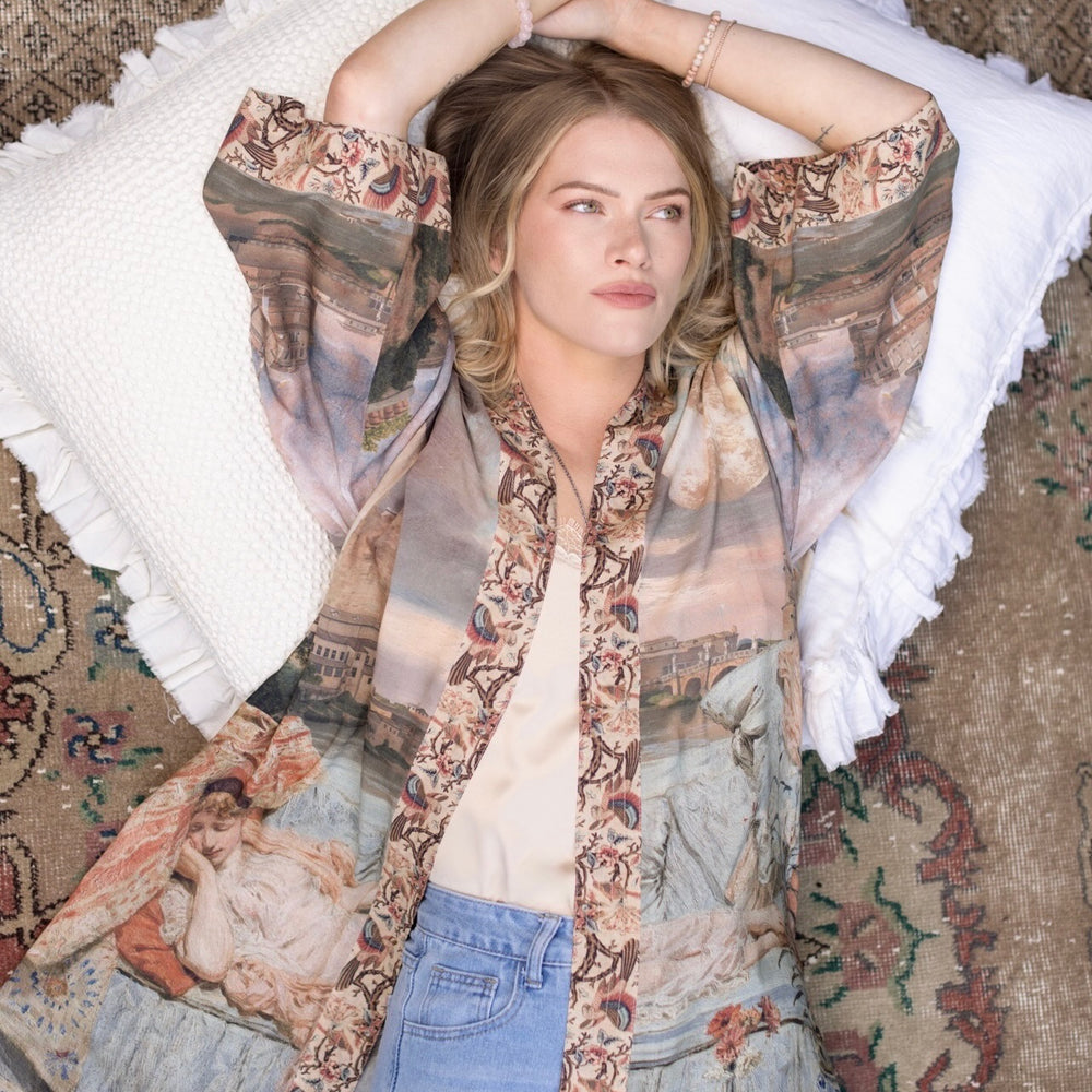 
                  
                    Model wearing the Imaginarium matinee duster featuring a dreamy collage of historic art, candle chandelier, and sleeping muse inspired by Victorian paintings – Market of Stars
                  
                