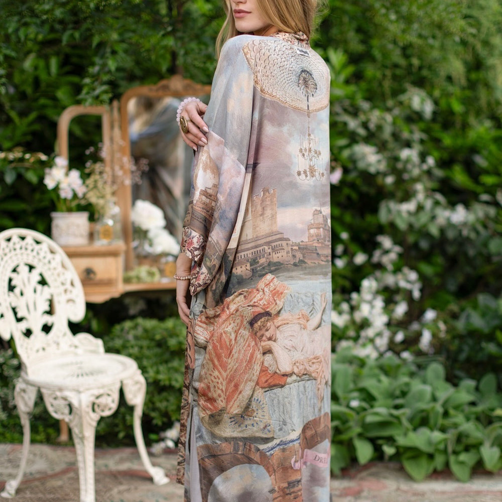 
                  
                    Model standing in airy Imaginarium opera duster featuring layered dreamscape art, candlelit chandelier, and sleeping muse inspired by Victorian paintings – Market of Stars
                  
                