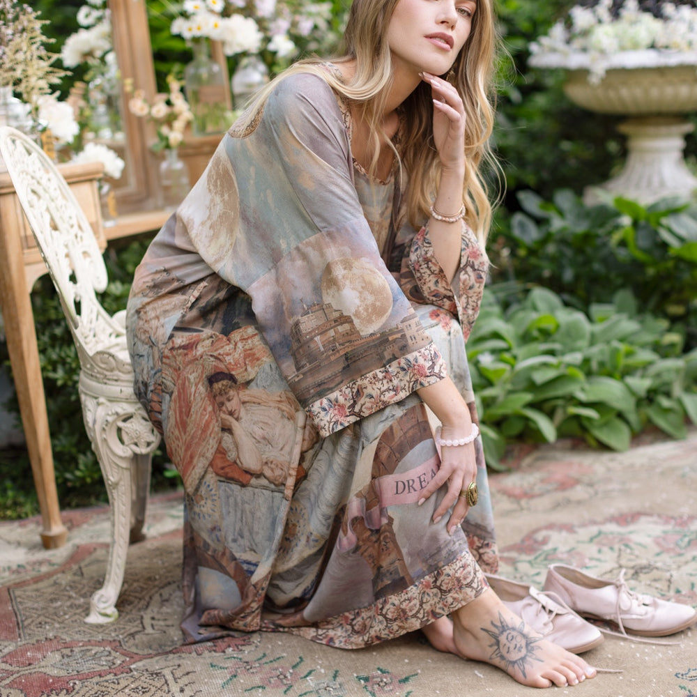 
                  
                    Model standing in airy Imaginarium opera duster featuring layered dreamscape art, candlelit chandelier, and sleeping muse inspired by Victorian paintings – Market of Stars
                  
                