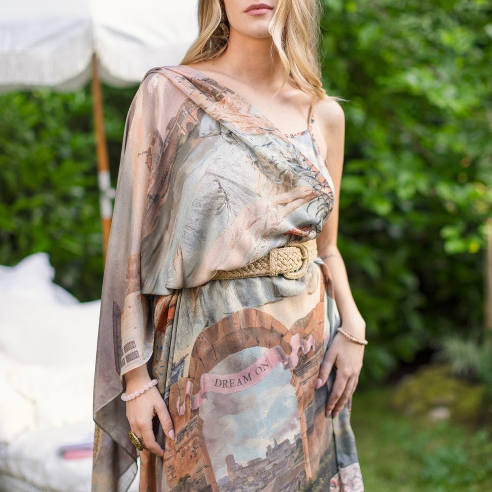 
                  
                    Model wearing airy Imaginarium scarf featuring a romantic collage of dreamy architecture, candlelight, and a sleeping muse – Market of Stars.
                  
                