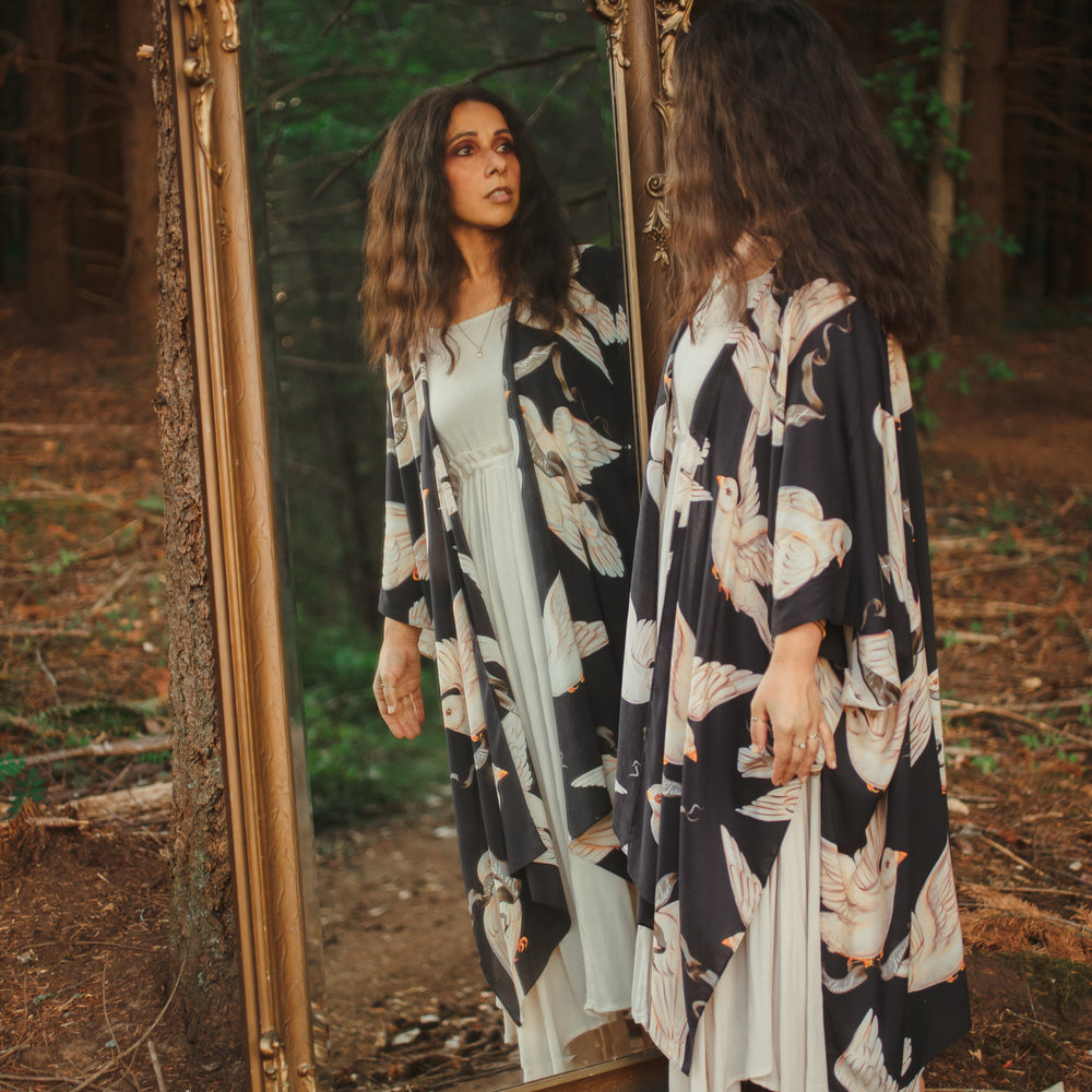 
                  
                    Model wearing the original Market of Stars kimono featuring Victorian-inspired doves and the words “In Stardust We Trust” — a tribute to dreams and possibility – Market of Stars.
                  
                
