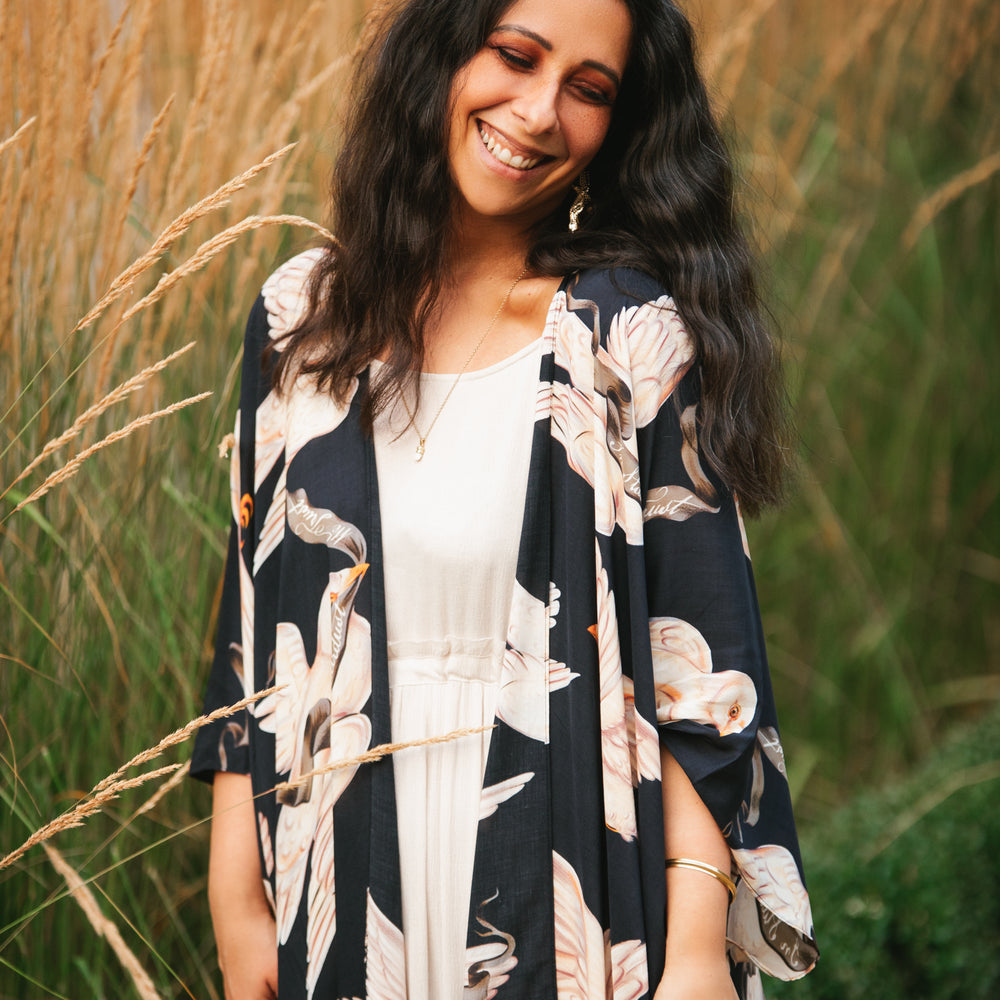 
                  
                    Model wearing the original Market of Stars kimono featuring Victorian-inspired doves and the words “In Stardust We Trust” — a tribute to dreams and possibility – Market of Stars.
                  
                