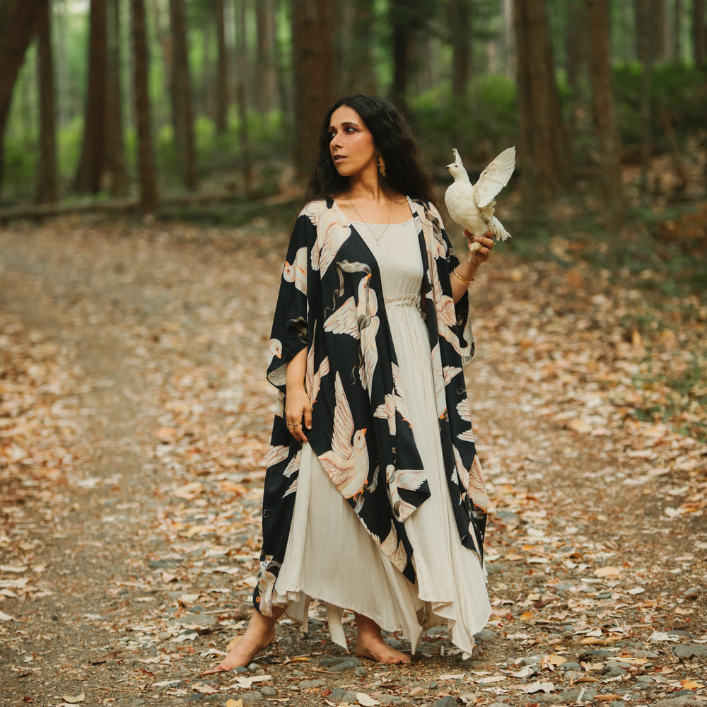 
                  
                    Model wearing the original Market of Stars kimono featuring Victorian-inspired doves and the words “In Stardust We Trust” — a tribute to dreams and possibility – Market of Stars.
                  
                