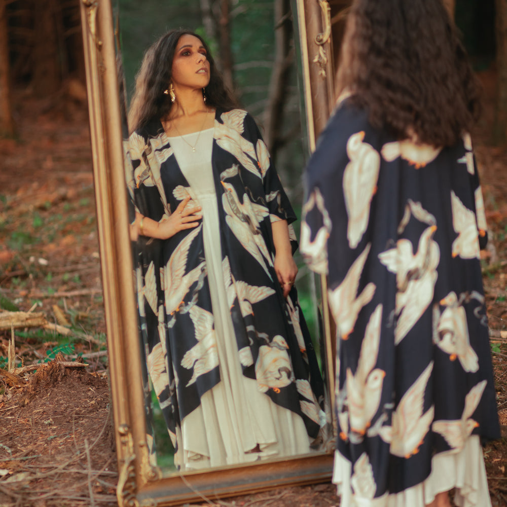 
                  
                    Model wearing the original Market of Stars kimono featuring Victorian-inspired doves and the words “In Stardust We Trust” — a tribute to dreams and possibility – Market of Stars.
                  
                
