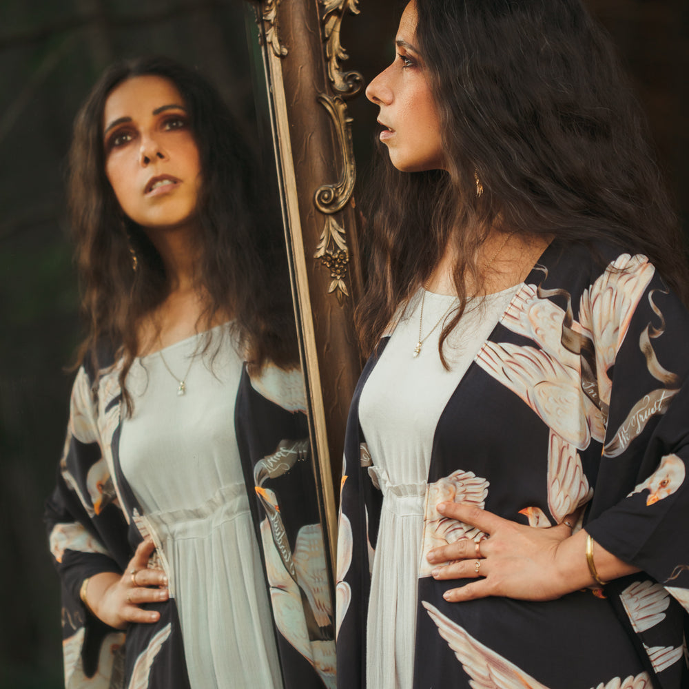 
                  
                    Model wearing the original Market of Stars kimono featuring Victorian-inspired doves and the words “In Stardust We Trust” — a tribute to dreams and possibility – Market of Stars.
                  
                