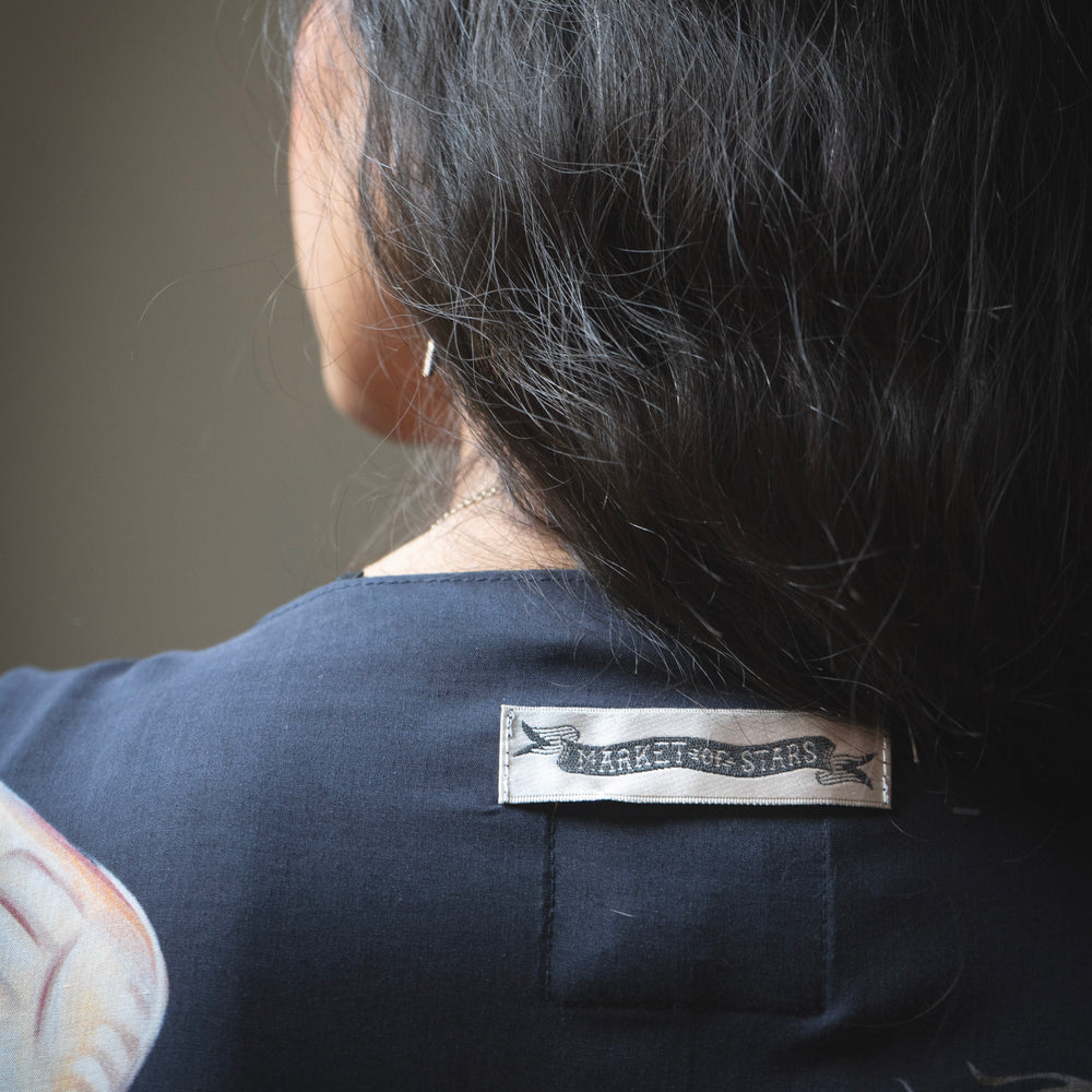 
                  
                    Model wearing the original Market of Stars kimono featuring Victorian-inspired doves and the words “In Stardust We Trust” — a tribute to dreams and possibility – Market of Stars.
                  
                
