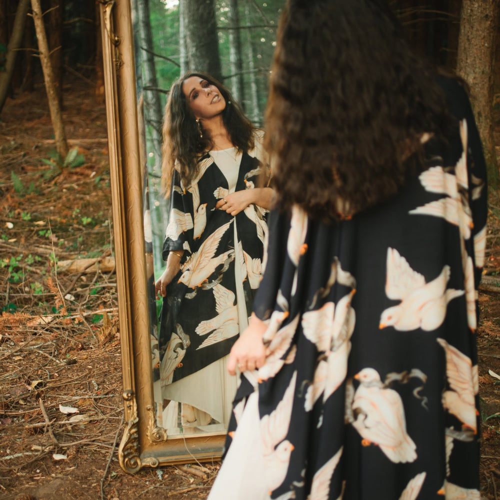 
                  
                    Model wearing the original Market of Stars kimono featuring Victorian-inspired doves and the words “In Stardust We Trust” — a tribute to dreams and possibility – Market of Stars.
                  
                