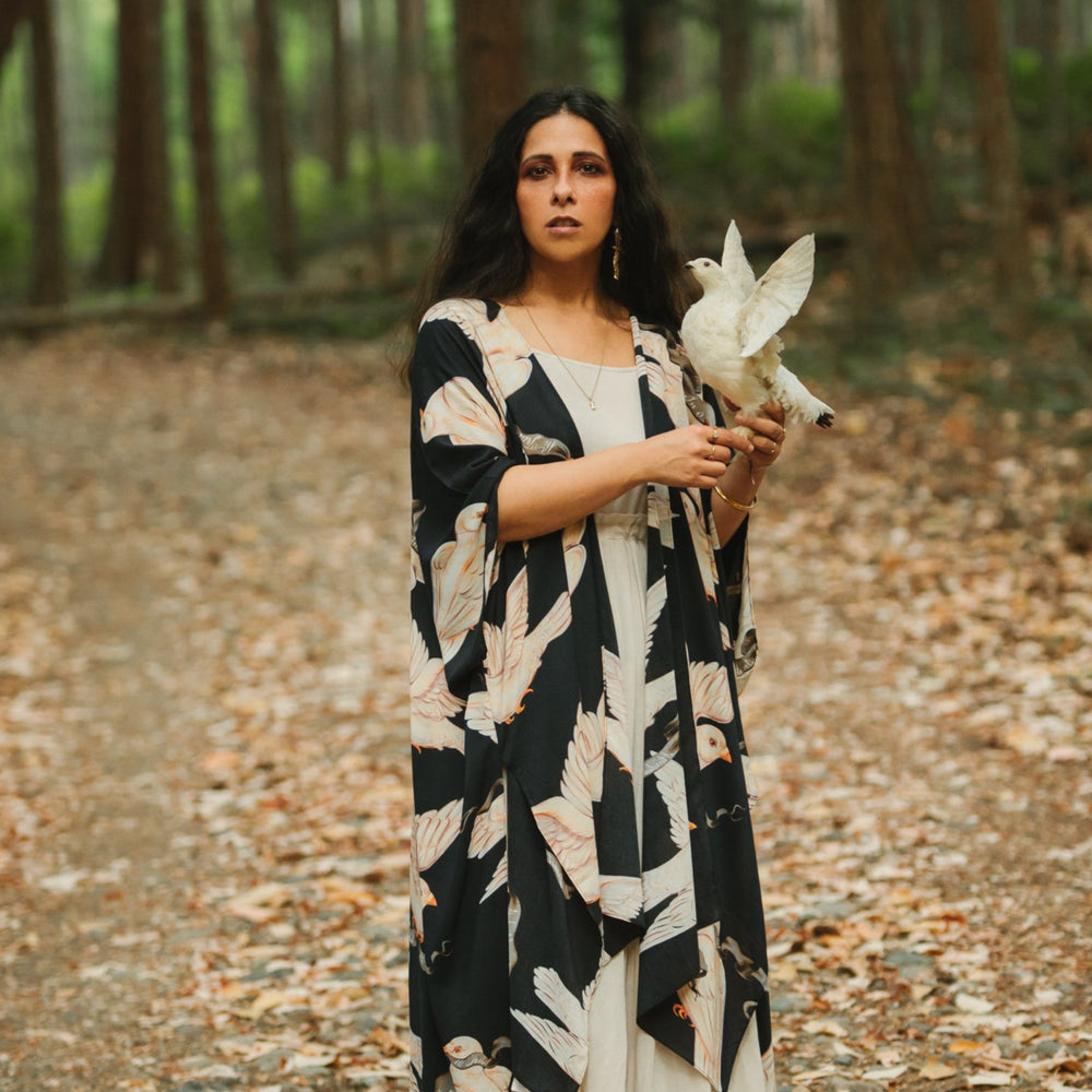 
                  
                    Model wearing the original Market of Stars kimono featuring Victorian-inspired doves and the words “In Stardust We Trust” — a tribute to dreams and possibility – Market of Stars.
                  
                