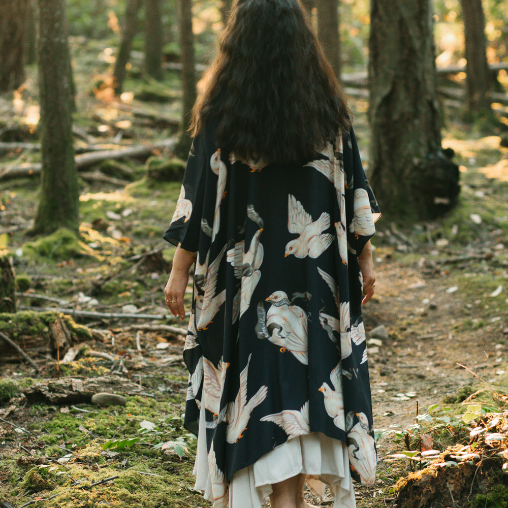 
                  
                    Model wearing the original Market of Stars kimono featuring Victorian-inspired doves and the words “In Stardust We Trust” — a tribute to dreams and possibility – Market of Stars.
                  
                