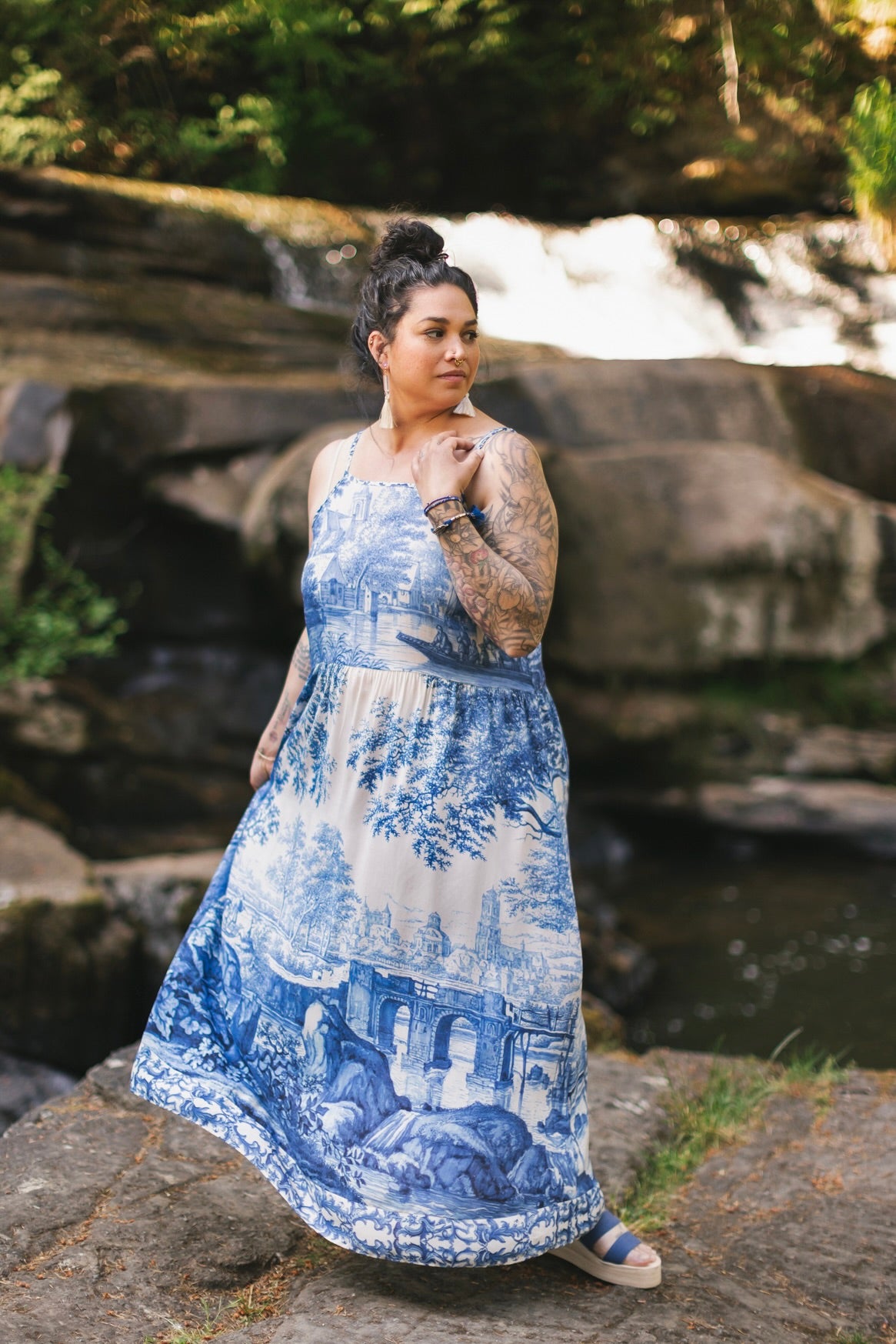 Model wearing Let the Light In bamboo viscose slip dress featuring print of Delft blue and white landscape pottery, and positive message of light and hope - Market of Stars