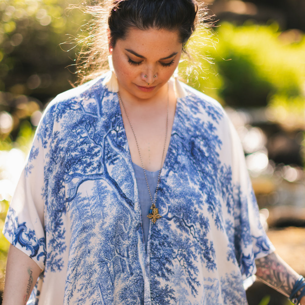 
                  
                    Model wearing Let the Light In Goddess kimono duster featuring print of Delft blue and white landscape pottery, and positive message of light and hope - Market of Stars
                  
                