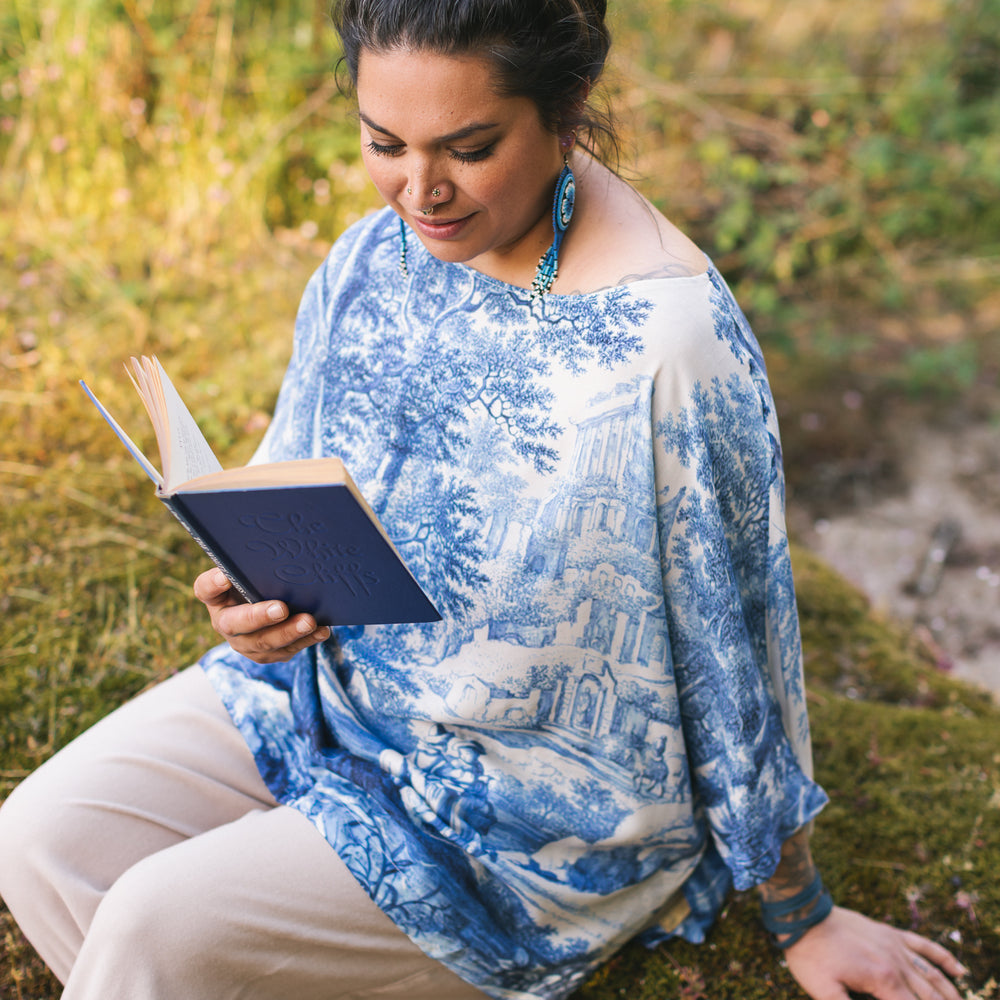 
                  
                    Model wearing Let the Light In bamboo viscose Luxe Tee shirt featuring print of Delft blue and white landscape pottery, and positive message of light and hope - Market of Stars
                  
                