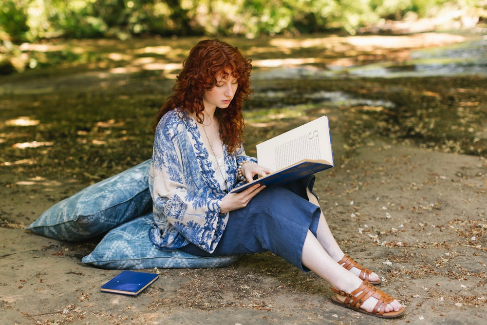 
                  
                    Model wearing Let the Light In cropped Pixie duster featuring print of Delft blue and white landscape pottery, and positive message of light and hope - Market of Stars
                  
                