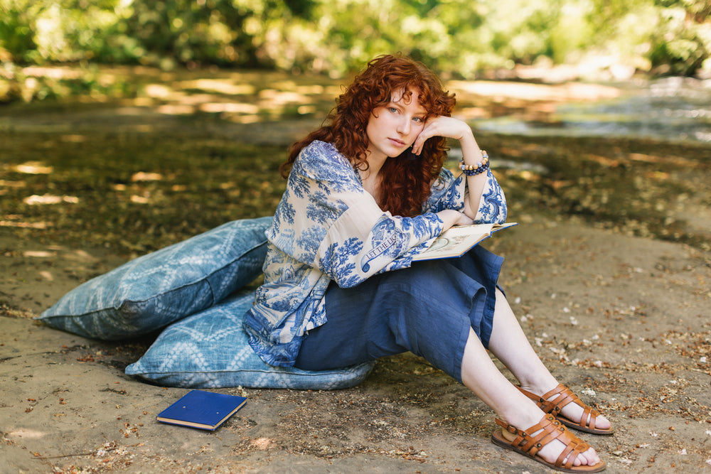 
                  
                    Model wearing Let the Light In cropped Pixie duster featuring print of Delft blue and white landscape pottery, and positive message of light and hope - Market of Stars
                  
                