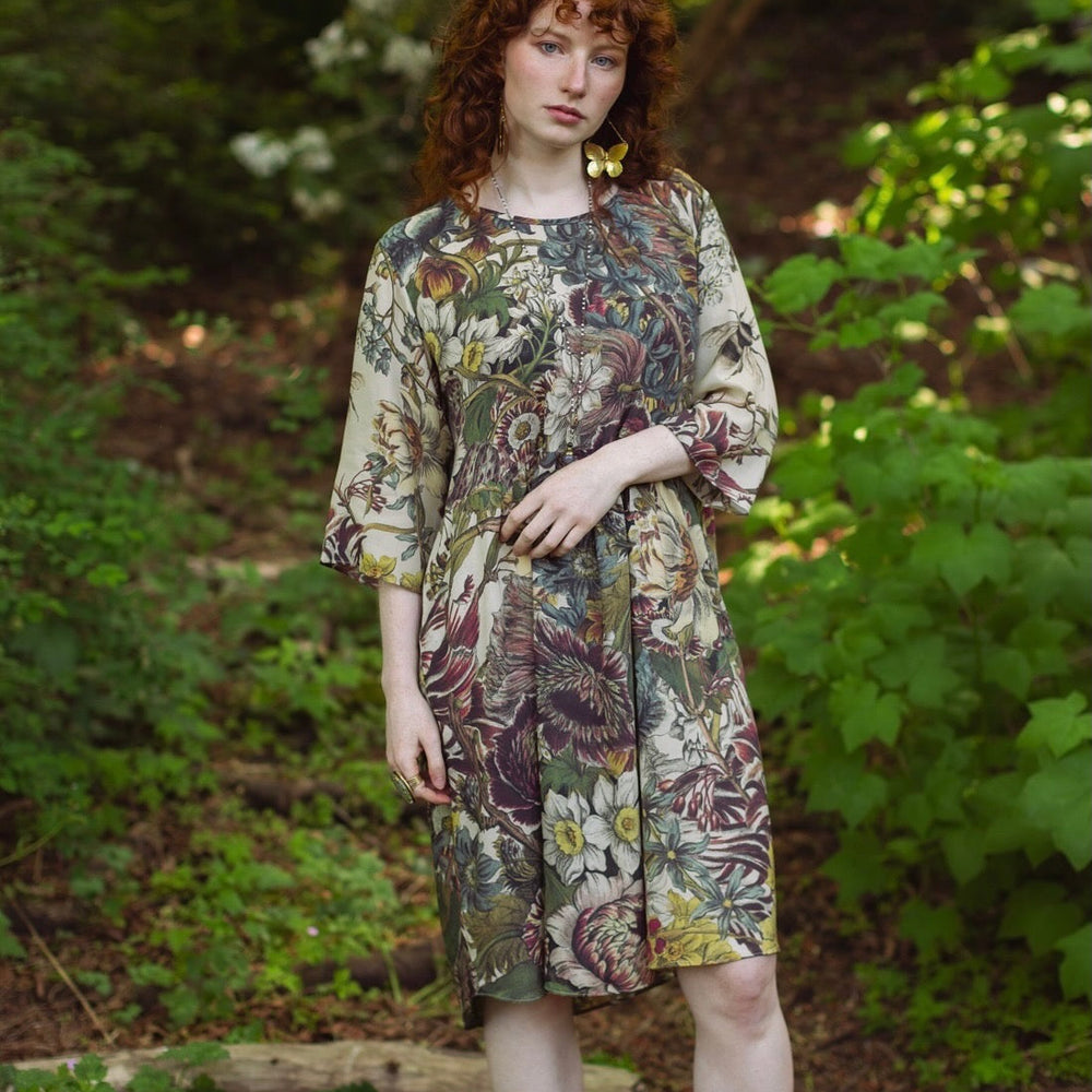 
                  
                    Model styled in Love Grows Wild Artist Dress featuring hand-coloured 1700s floral etchings and bumblebee detail – inspired by the French chemise – Market of Stars
                  
                