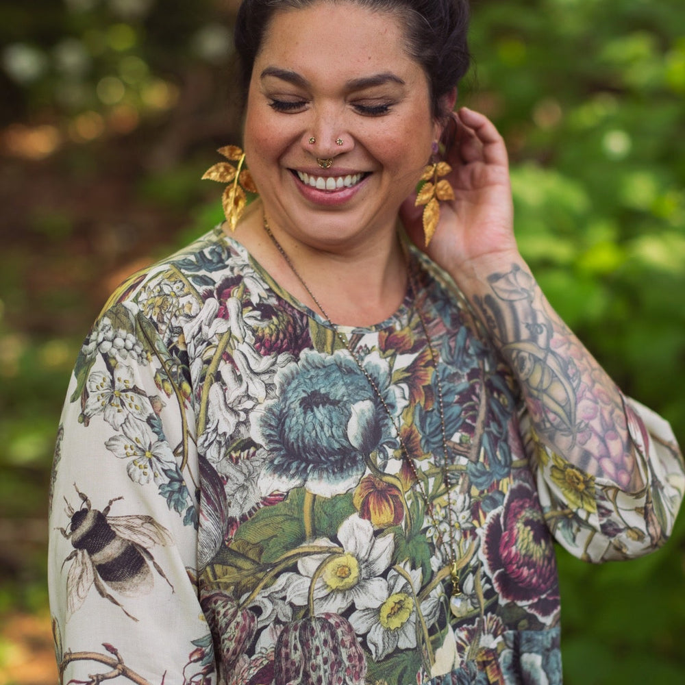 
                  
                    Model styled in Love Grows Wild Artist Dress featuring hand-coloured 1700s floral etchings and bumblebee detail – inspired by the French chemise – Market of Stars
                  
                