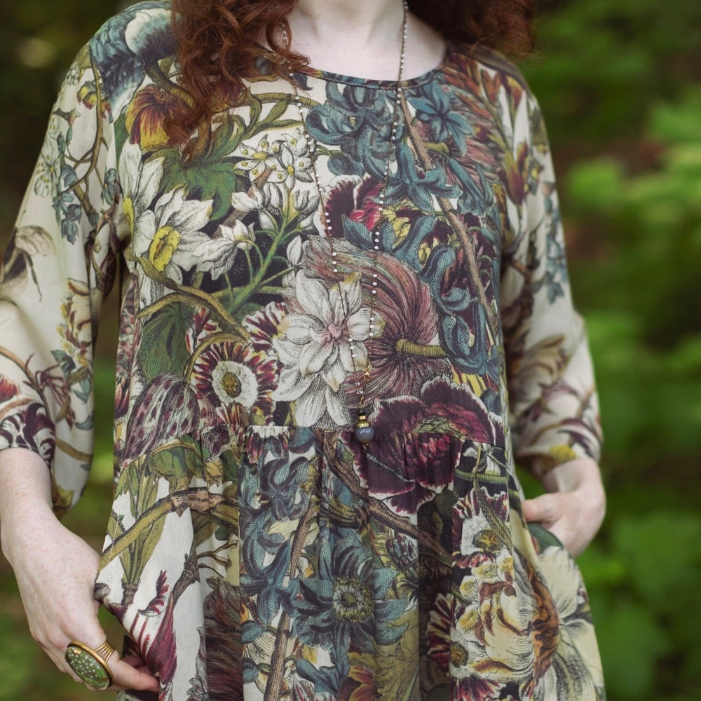
                  
                    Model styled in Love Grows Wild Artist Dress featuring hand-coloured 1700s floral etchings and bumblebee detail – inspired by the French chemise – Market of Stars
                  
                