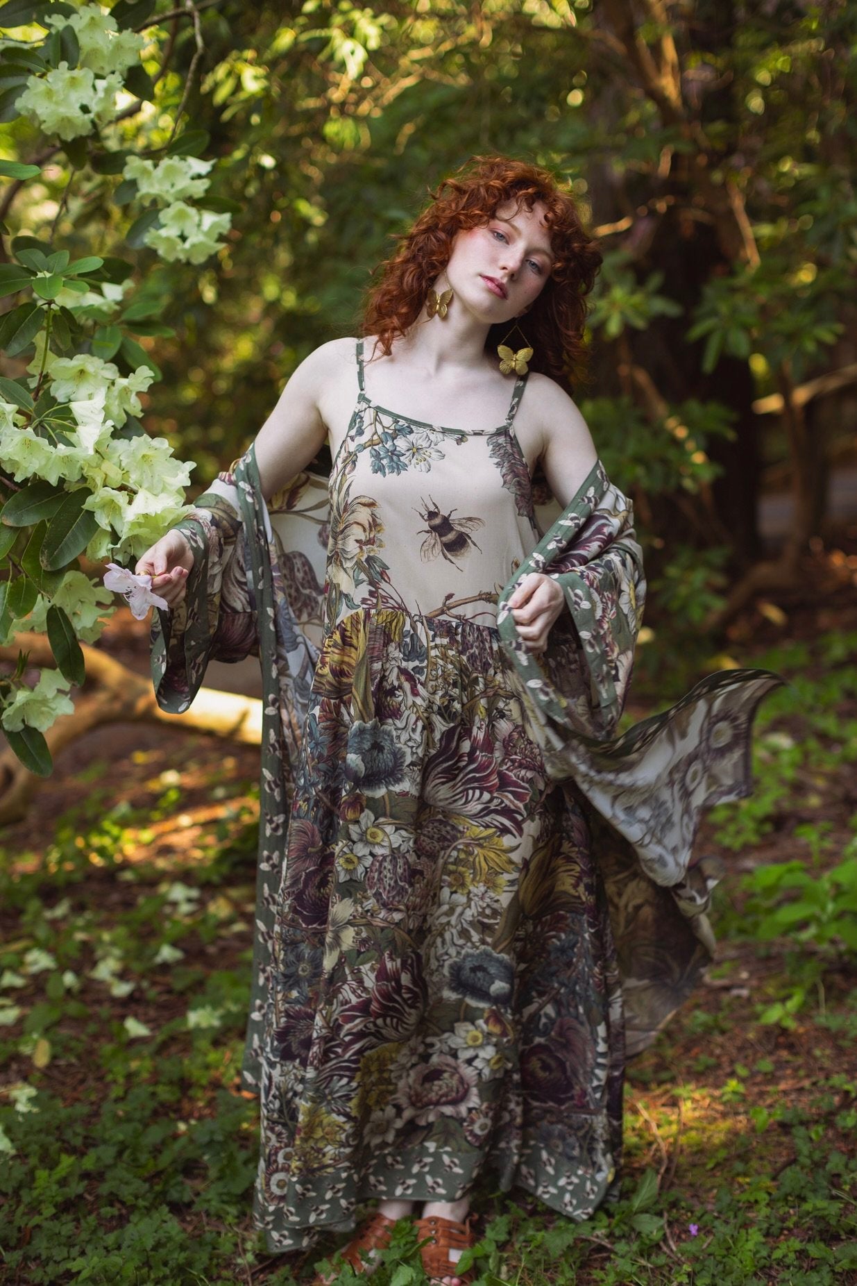 Model wearing Love Grows Wild Bohéme Slip Dress featuring hand-coloured 1700s botanical etchings and bumblebee detail – adjustable, flowy, and reversible – Market of Stars.