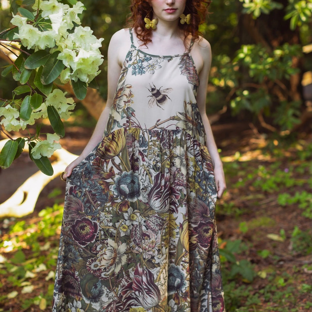 Model wearing Love Grows Wild Bohéme Slip Dress featuring hand-coloured 1700s botanical etchings and bumblebee detail – adjustable, flowy, and reversible – Market of Stars.