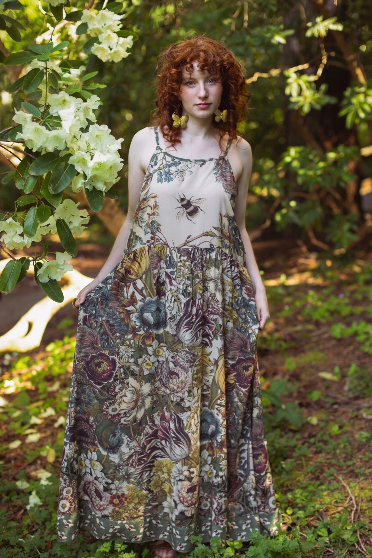 Model wearing Love Grows Wild Bohéme Slip Dress featuring hand-coloured 1700s botanical etchings and bumblebee detail – adjustable, flowy, and reversible – Market of Stars.