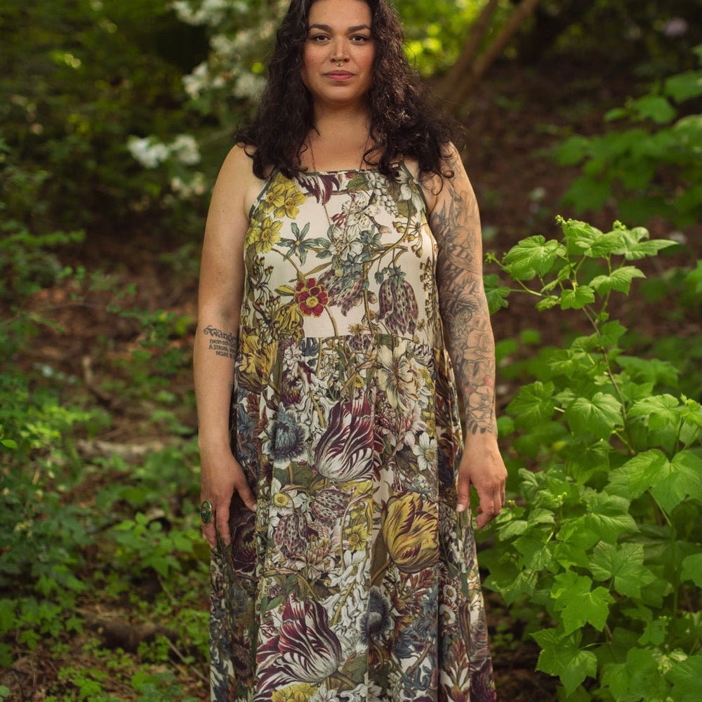 
                  
                    Model wearing Love Grows Wild Bohéme Slip Dress featuring hand-coloured 1700s botanical etchings and bumblebee detail – adjustable, flowy, and reversible – Market of Stars.
                  
                