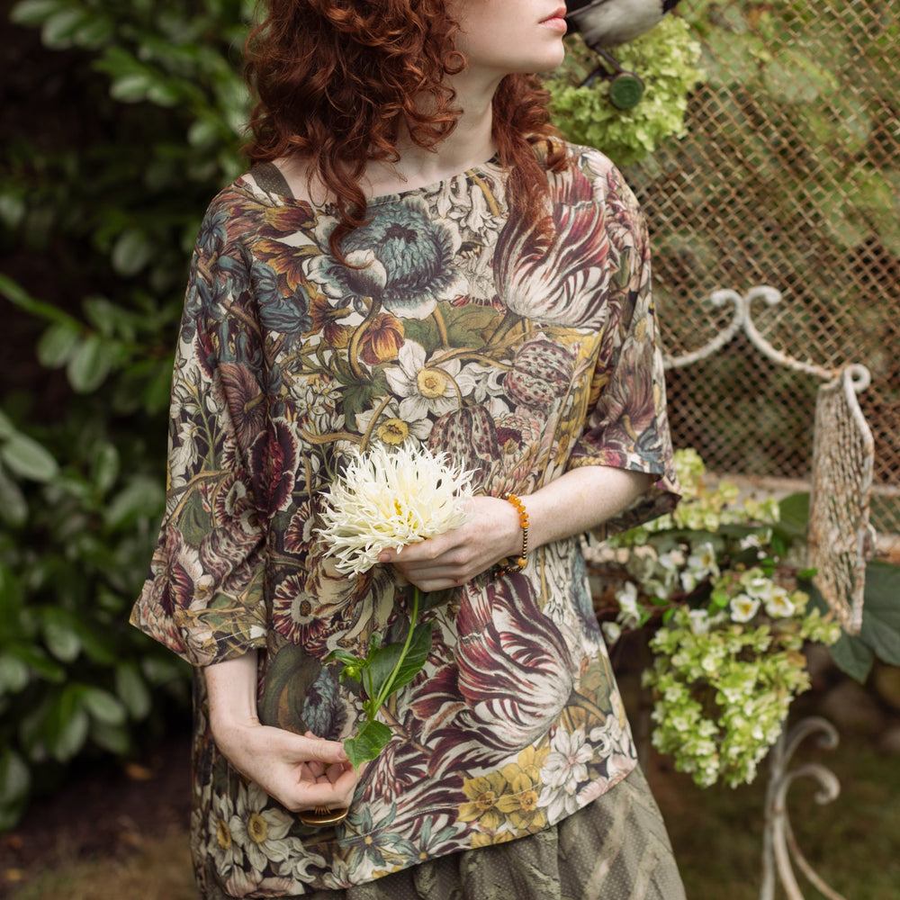 Model wearing the Love Grows Wild Luxe Tee featuring lush floral etchings inspired by 1700s botanical art with hidden bee trim detail – Market of Stars.