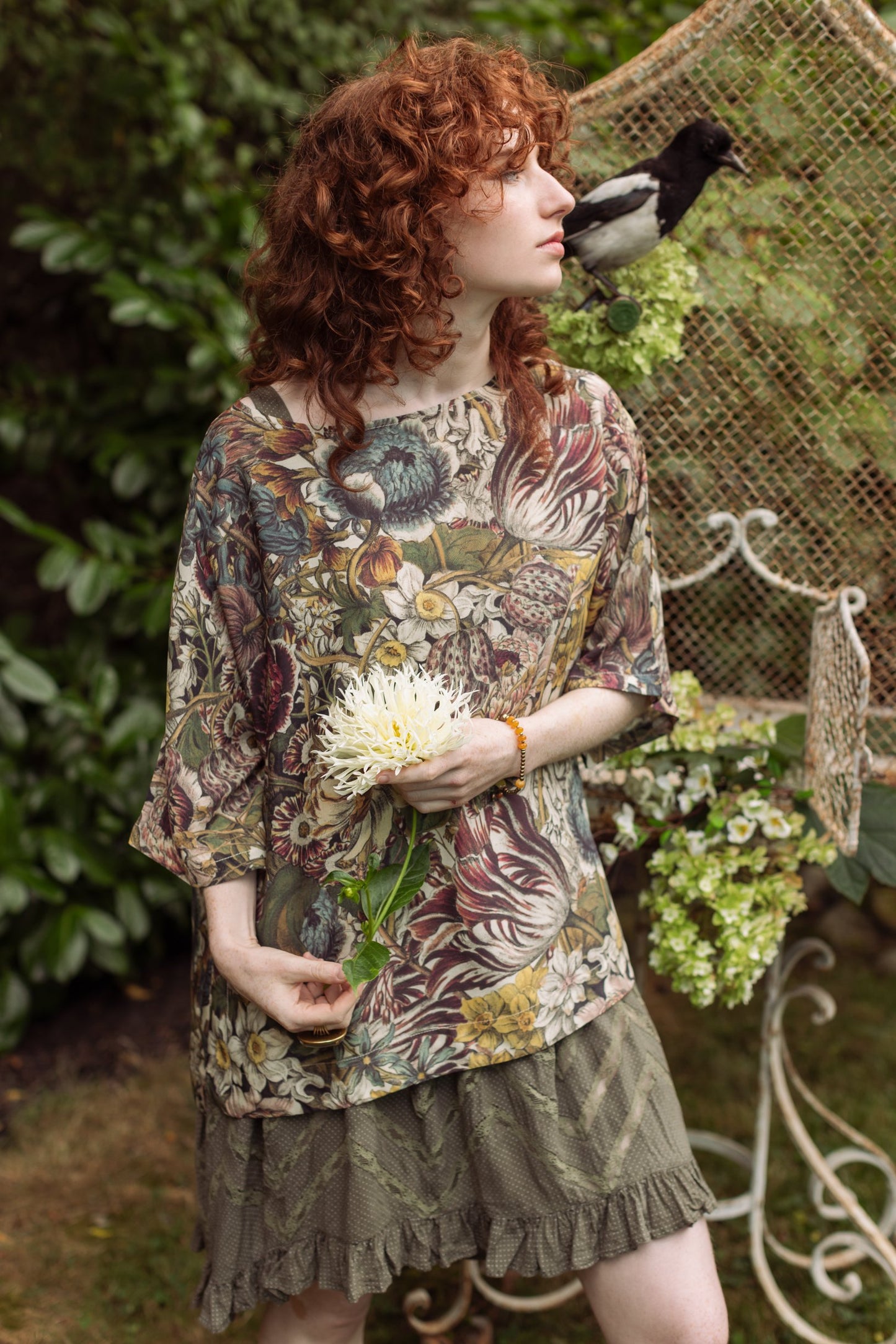 Model wearing the Love Grows Wild Luxe Tee featuring lush floral etchings inspired by 1700s botanical art with hidden bee trim detail – Market of Stars.