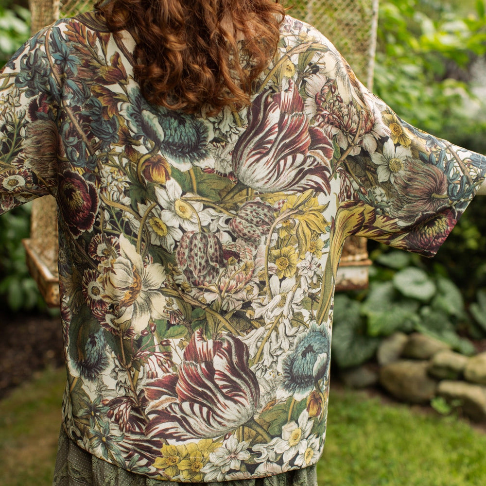 Model wearing the Love Grows Wild Luxe Tee featuring lush floral etchings inspired by 1700s botanical art with hidden bee trim detail – Market of Stars.