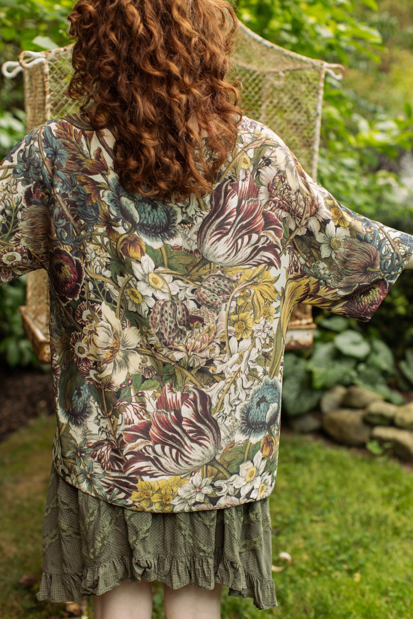 Model wearing the Love Grows Wild Luxe Tee featuring lush floral etchings inspired by 1700s botanical art with hidden bee trim detail – Market of Stars.