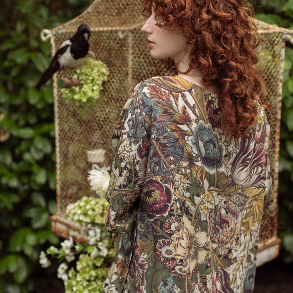
                  
                    Model wearing the Love Grows Wild Luxe Tee featuring lush floral etchings inspired by 1700s botanical art with hidden bee trim detail – Market of Stars.
                  
                