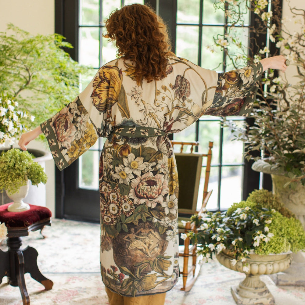 
                  
                    Model wearing kimono featuring 1700s March floral etchings and charming bumblebee trim inspired by vintage seed catalogues – Market of Stars.
                  
                