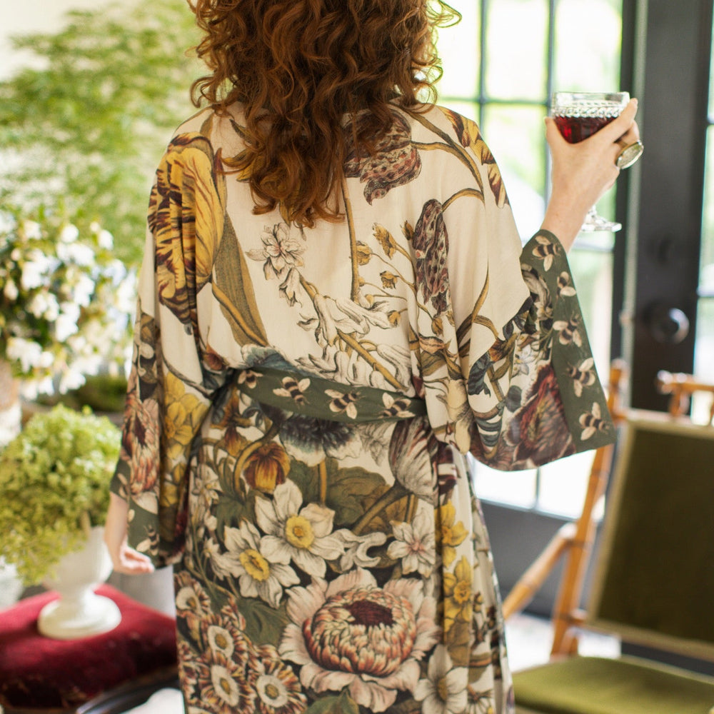 
                  
                    Model wearing kimono featuring 1700s March floral etchings and charming bumblebee trim inspired by vintage seed catalogues – Market of Stars.
                  
                