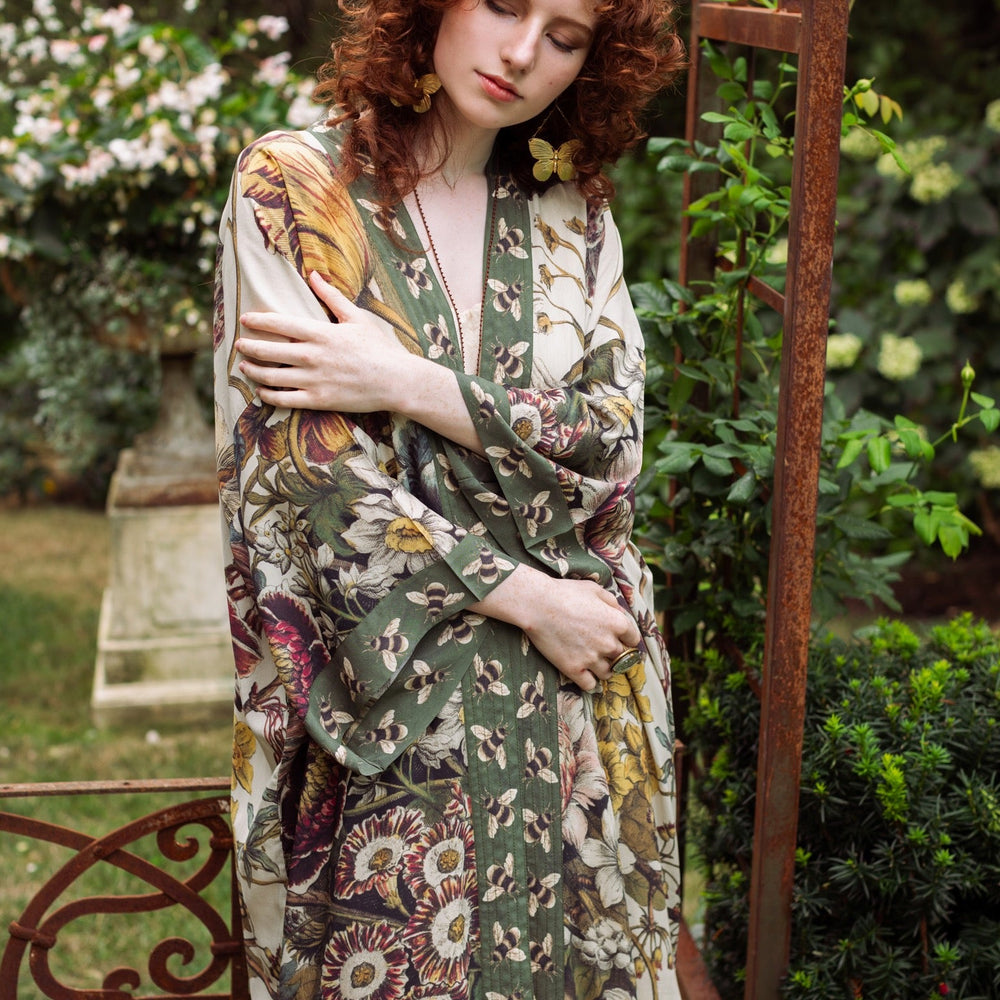 
                  
                    Model wearing kimono featuring 1700s March floral etchings and charming bumblebee trim inspired by vintage seed catalogues – Market of Stars.
                  
                