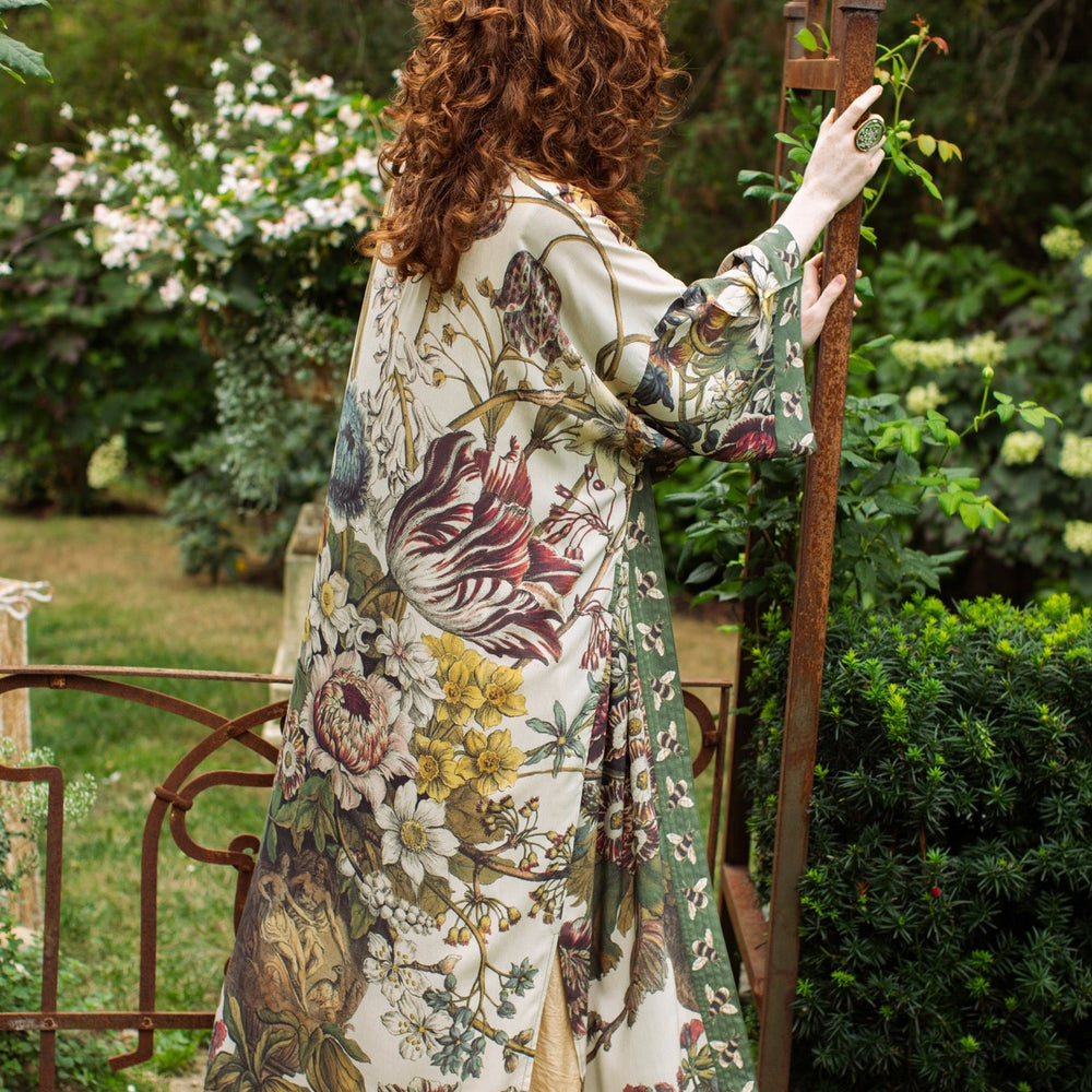 
                  
                    Model wearing kimono featuring 1700s March floral etchings and charming bumblebee trim inspired by vintage seed catalogues – Market of Stars.
                  
                