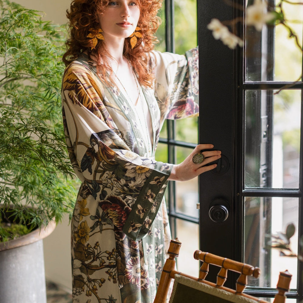 
                  
                    Model wearing kimono featuring 1700s March floral etchings and charming bumblebee trim inspired by vintage seed catalogues – Market of Stars.
                  
                
