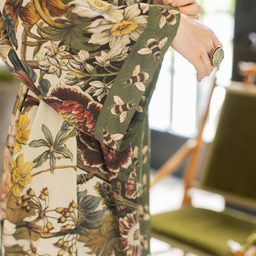 
                  
                    Model wearing kimono featuring 1700s March floral etchings and charming bumblebee trim inspired by vintage seed catalogues – Market of Stars.
                  
                