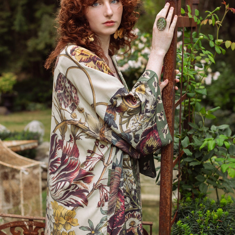 
                  
                    Model wearing kimono featuring 1700s March floral etchings and charming bumblebee trim inspired by vintage seed catalogues – Market of Stars.
                  
                