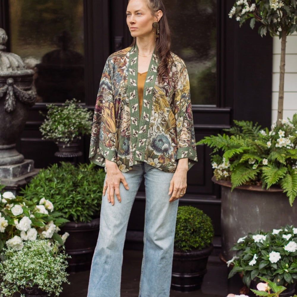 
                  
                    Model wearing Love Grows Wild Pixie Duster featuring hand-coloured 1700s floral etchings and charming bumblebee trim, celebrating the joy of abundance – Market of Stars.
                  
                
