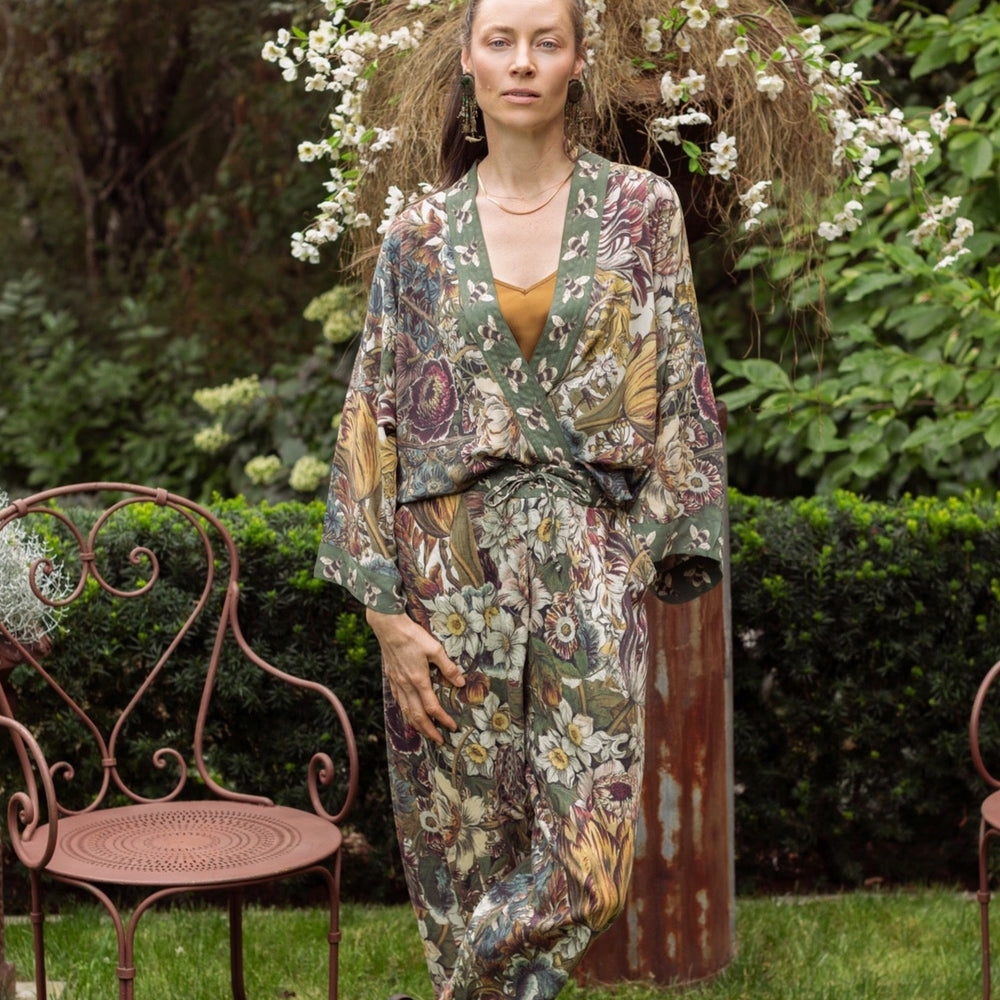
                  
                    Model wearing Love Grows Wild Pixie Duster featuring hand-coloured 1700s floral etchings and charming bumblebee trim, celebrating the joy of abundance – Market of Stars.
                  
                