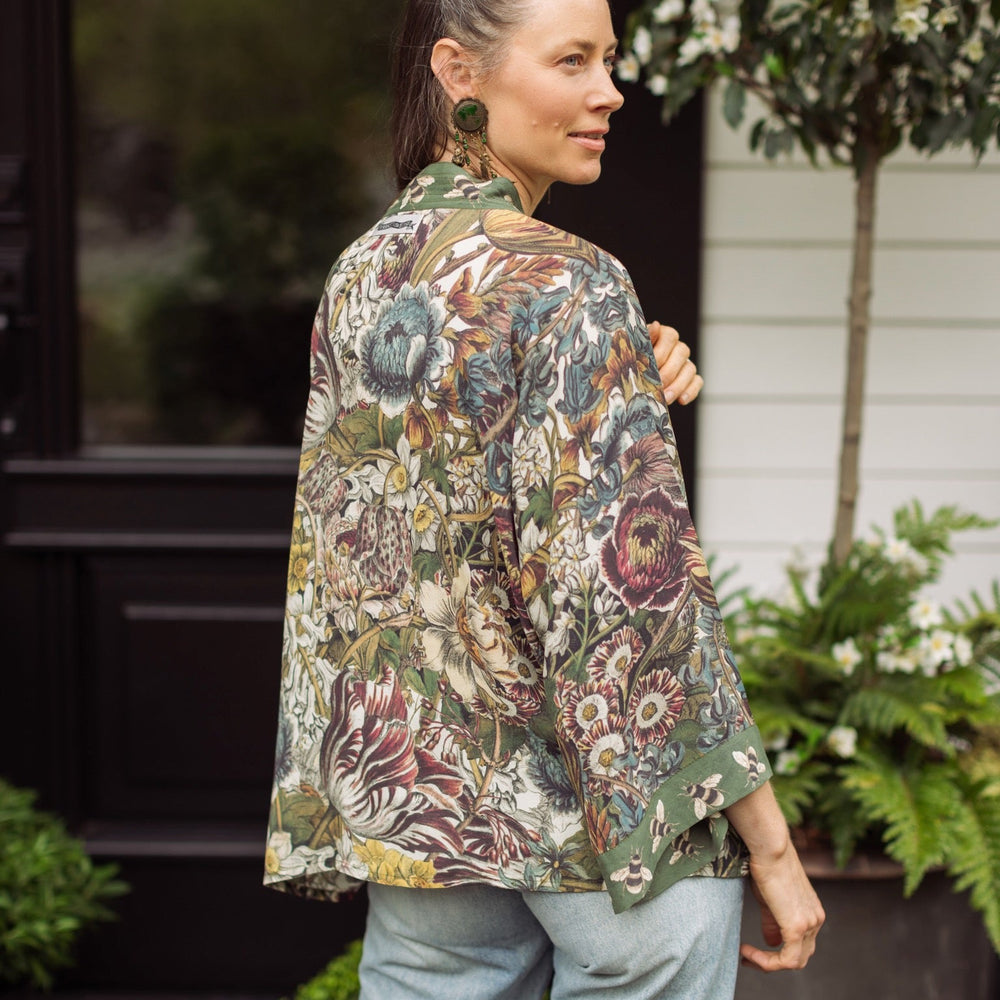
                  
                    Model wearing Love Grows Wild Pixie Duster featuring hand-coloured 1700s floral etchings and charming bumblebee trim, celebrating the joy of abundance – Market of Stars.
                  
                