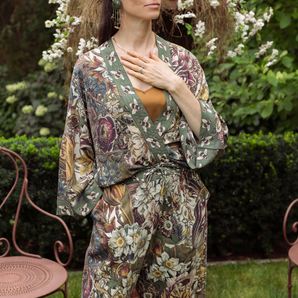 
                  
                    Model wearing Love Grows Wild Pixie Duster featuring hand-coloured 1700s floral etchings and charming bumblebee trim, celebrating the joy of abundance – Market of Stars.
                  
                