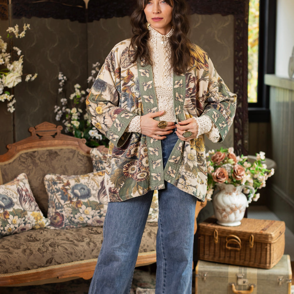 
                  
                    Model wearing a soft cotton velvet duster featuring lush 1700s botanical blooms and bumblebee trim - Market of Stars
                  
                
