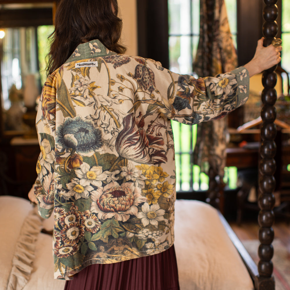 
                  
                    Model wearing a soft cotton velvet duster featuring lush 1700s botanical blooms and bumblebee trim - Market of Stars
                  
                