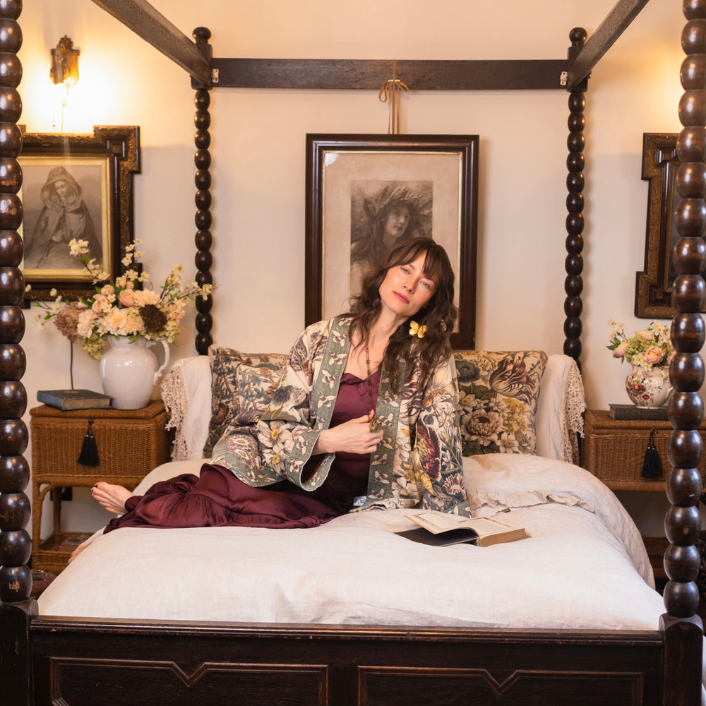 
                  
                    Model wearing a soft cotton velvet duster featuring lush 1700s botanical blooms and bumblebee trim - Market of Stars
                  
                