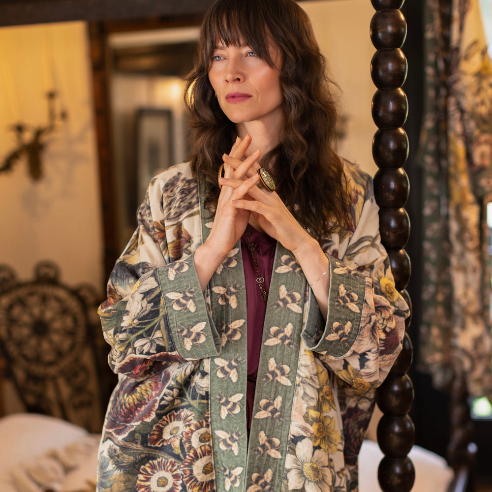 
                  
                    Model wearing a soft cotton velvet duster featuring lush 1700s botanical blooms and bumblebee trim - Market of Stars
                  
                